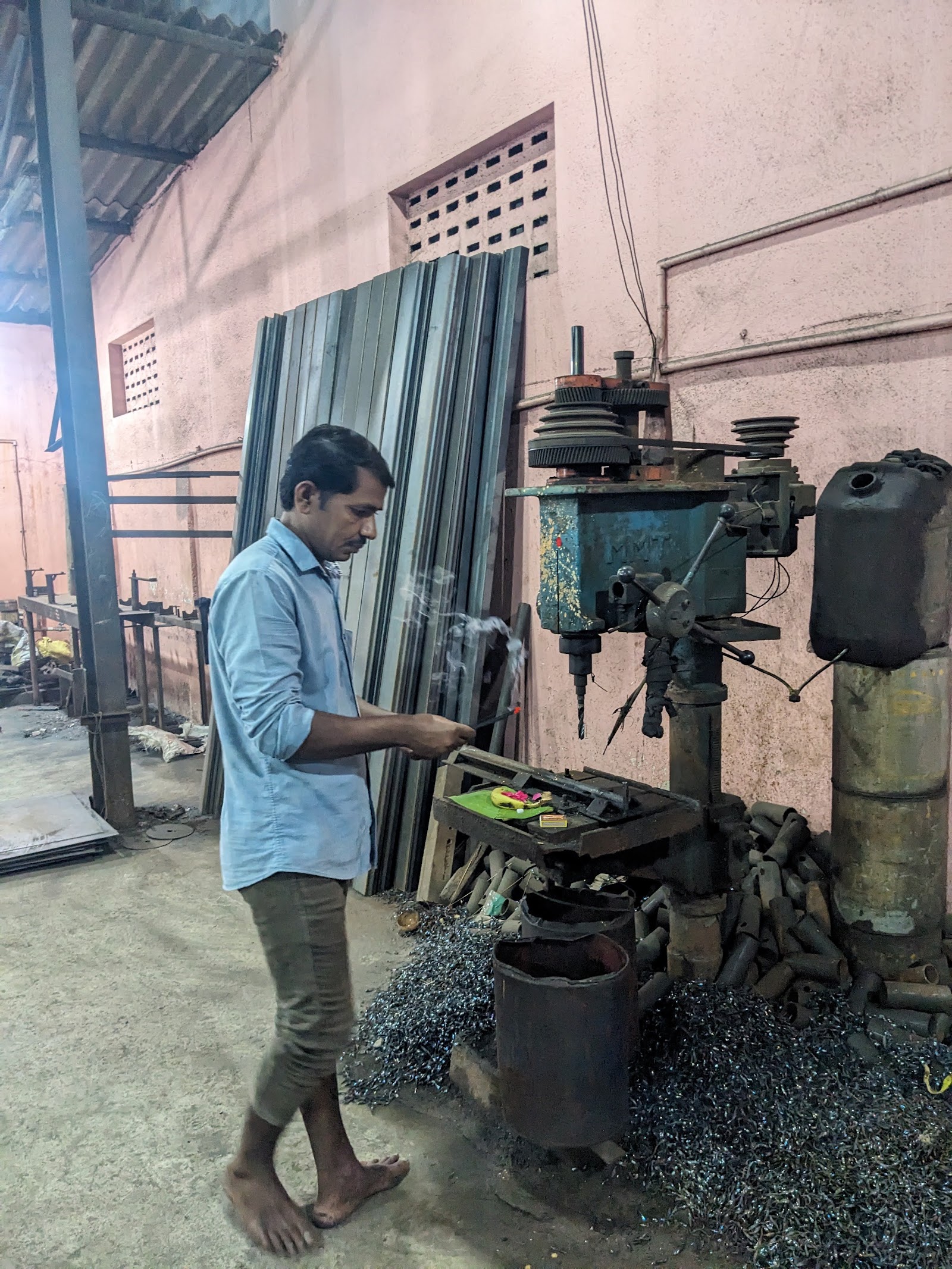 Team member working at the workshop drilling machine
