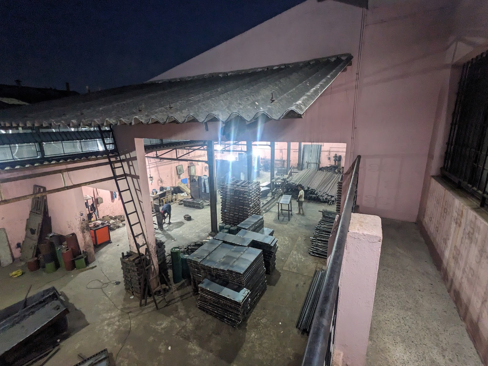 Overview of the Ambattur workshop with fabricated components and steel stock